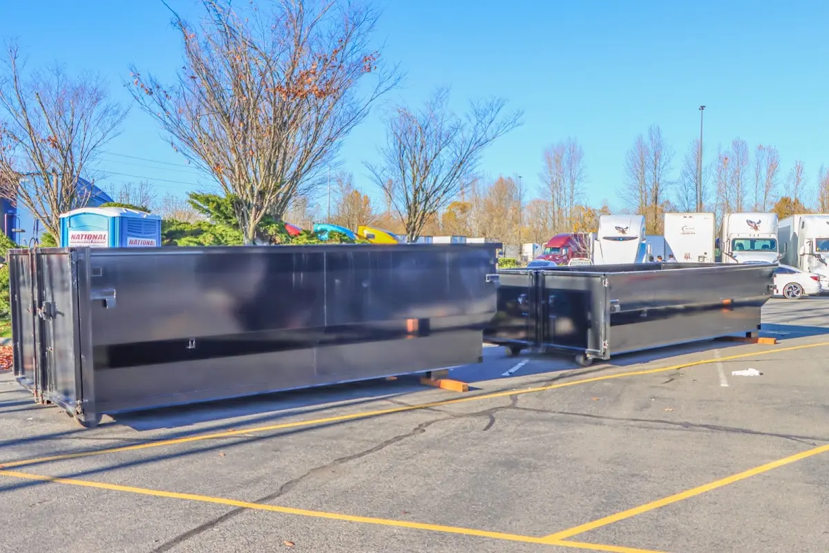 Professional dumpster rental service with roll-off container on residential driveway in Hialeah